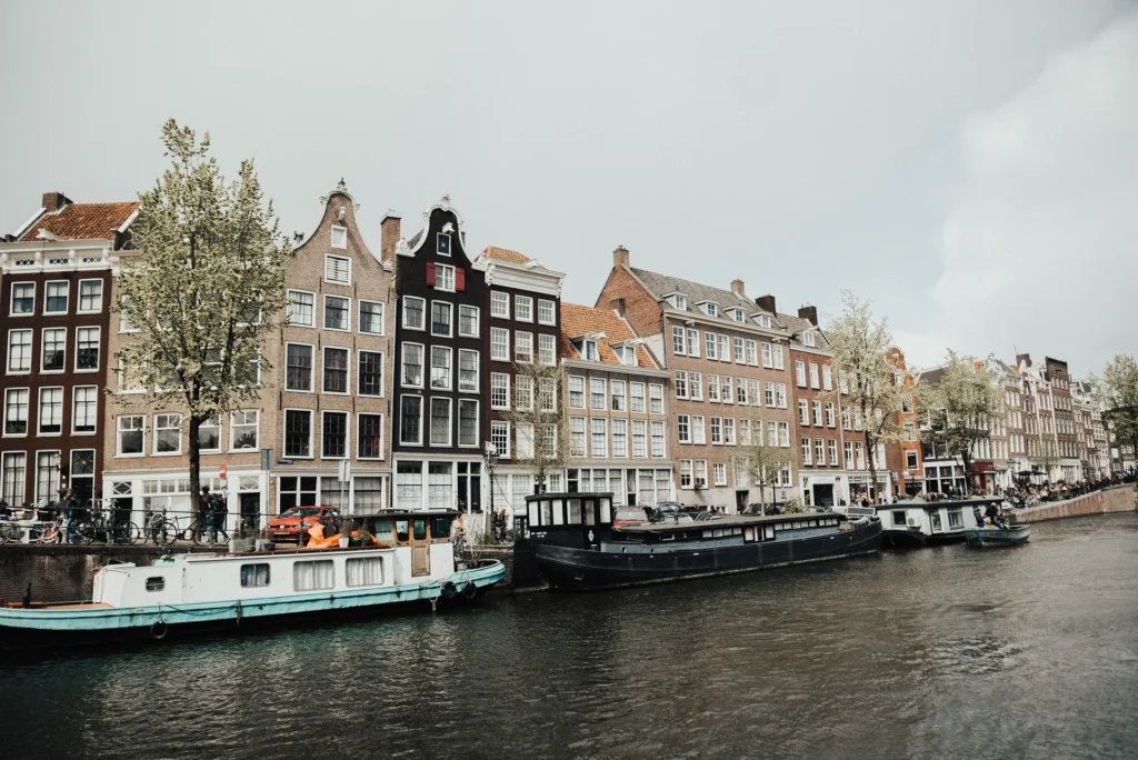 Traditional canal houses and houseboats along a canal in Amsterdam, Netherlands