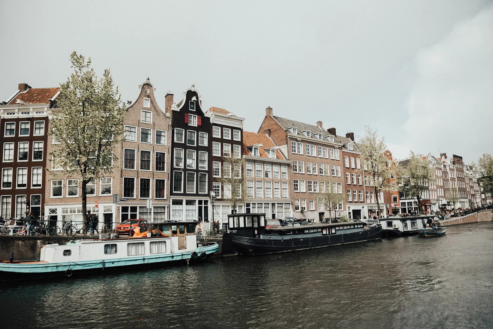Traditional canal houses and houseboats along a canal in Amsterdam, Netherlands