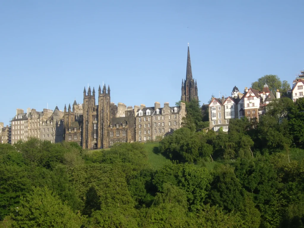 Edinburgh Old Town skyline with spires above green trees, Scotland